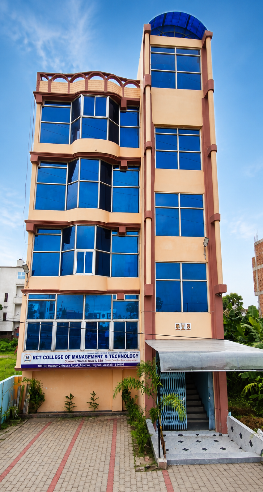 Modern college campus building with green lawn